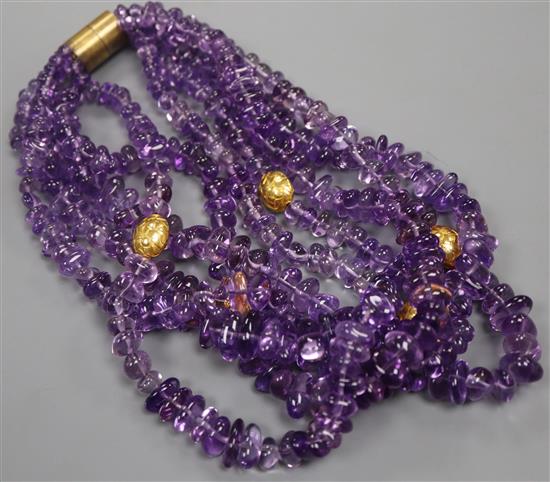 An amethyst torsade necklace by Kiki McDonough, composed of five strands of tumbled graduated amethyst beads